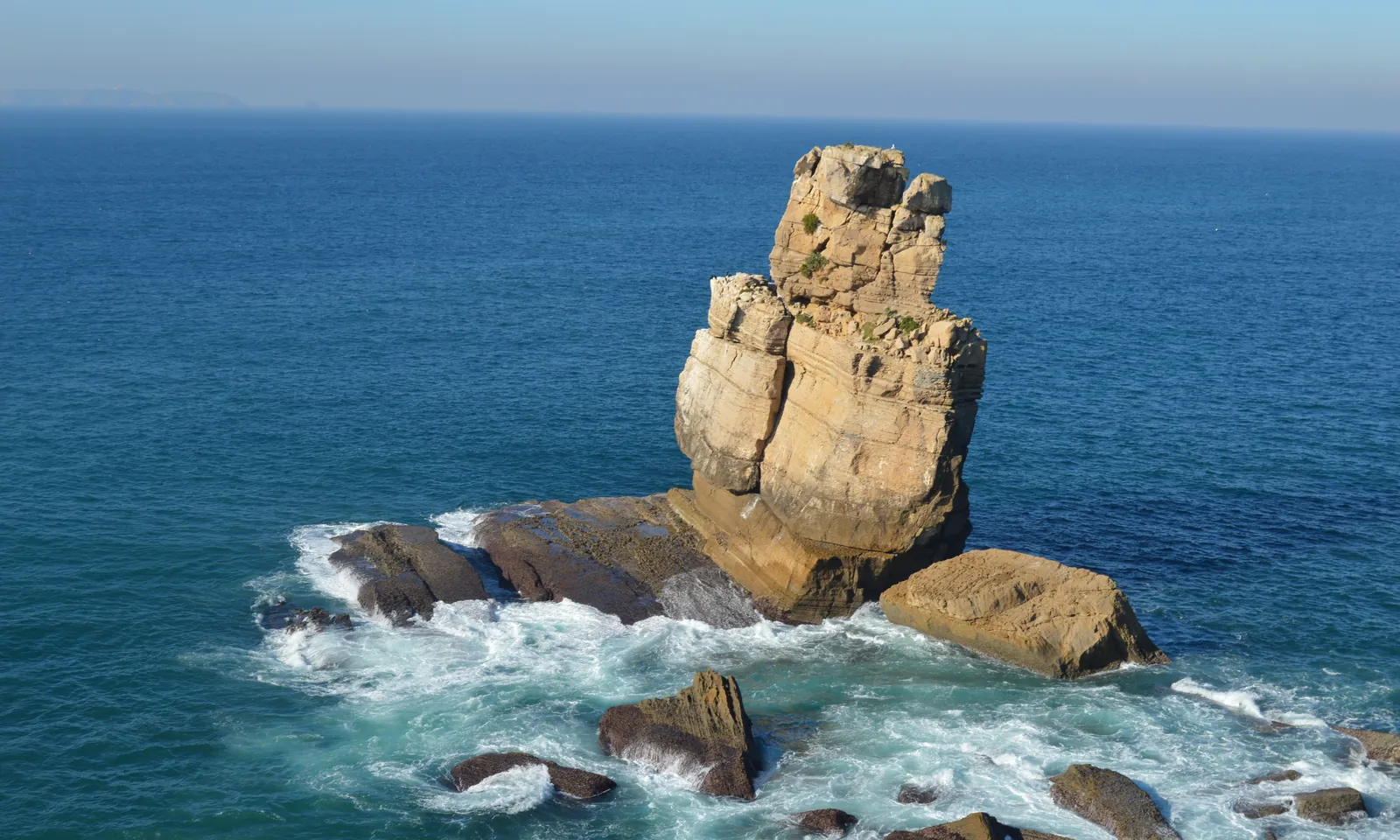 The Nau dos Corvos sea stack at Cabo Carvoeiro, Peniche, surrounded by foaming Atlantic water