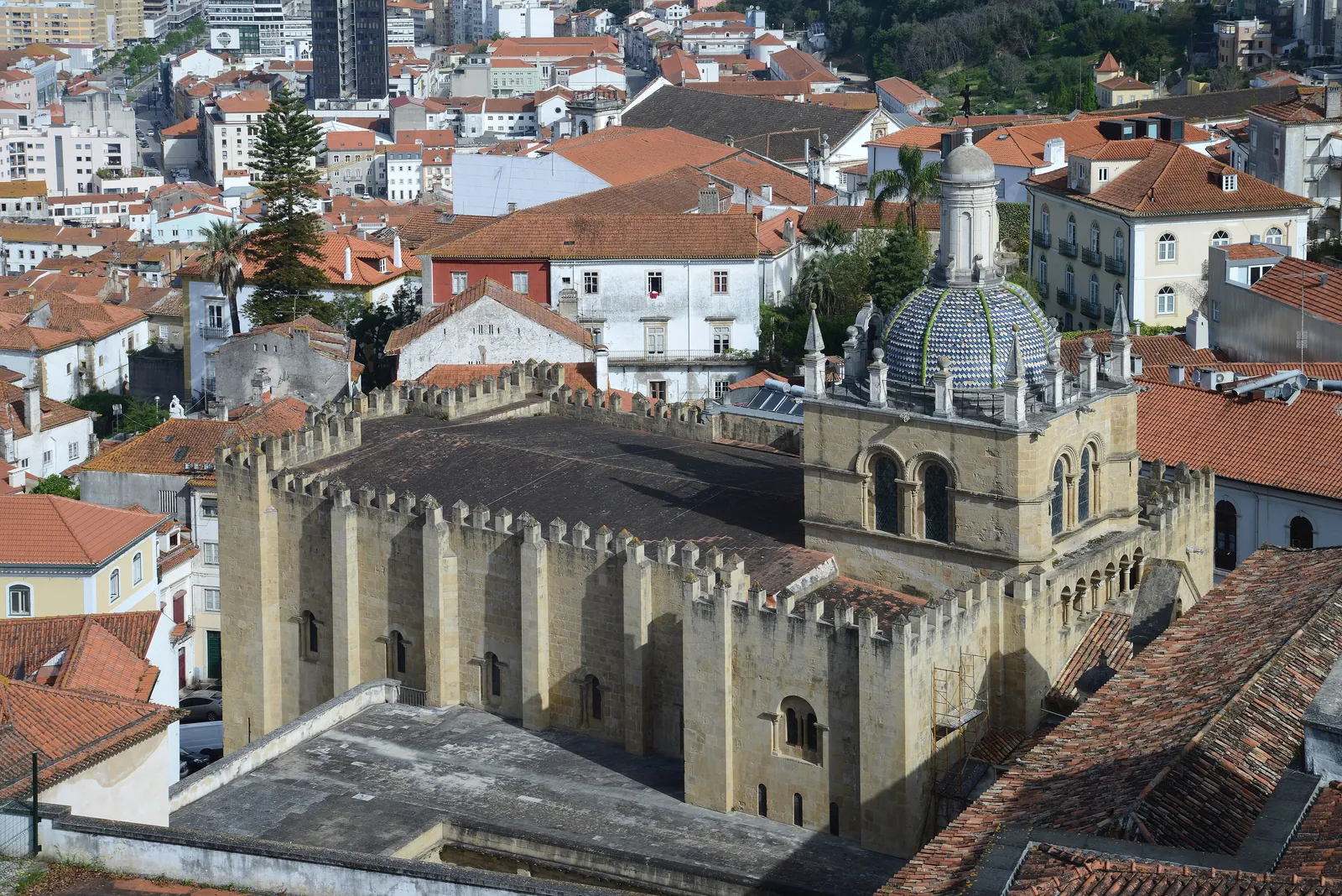 The fortress-like Romanesque Sé Velha of Coimbra seen from above, surrounded by the terracotta roofs of the old town